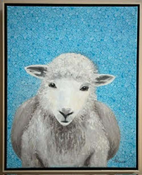 Face of baby lamb on blue background.